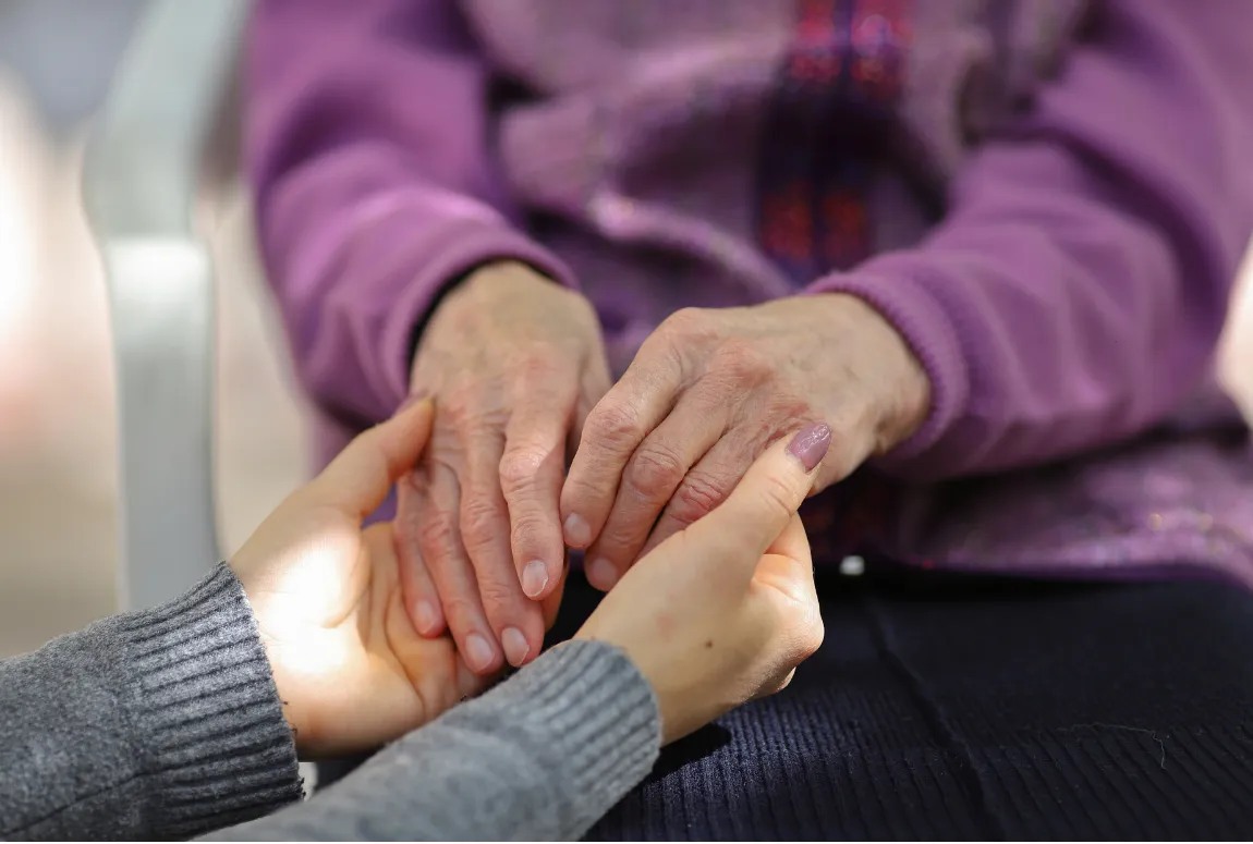 Resident and Team Member Holding Hands